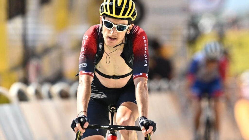 Person cycling outdoors wearing a heart rate monitor for Zone 2 cardio training